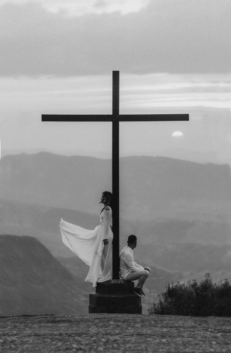 man-and-woman-pose-on-a-cross-monument-2917381